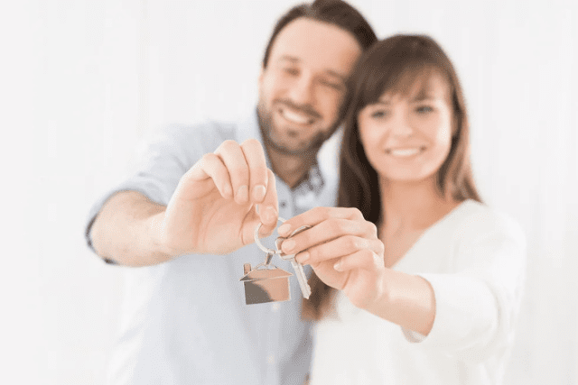 a-young-couple-holding-hands-house-key-the-joy-of-a-new-apartment