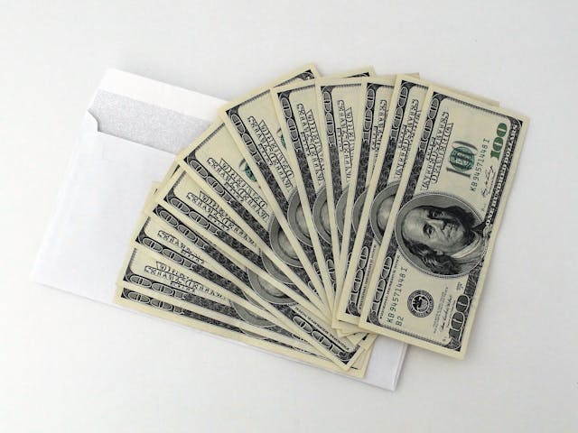 hundred-dollar-bills-fanned-out-from-envelope