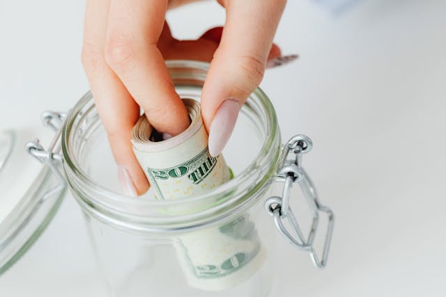 Money going into a jar
