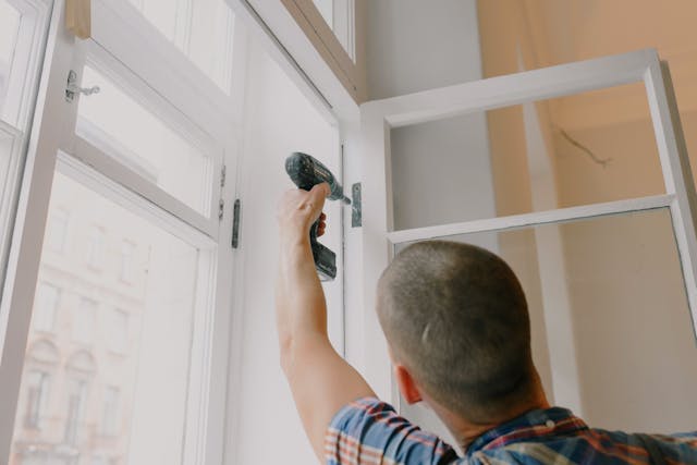 A person repairing a window